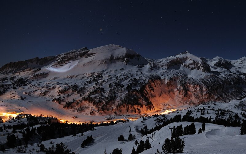 Snowy mountain village at night