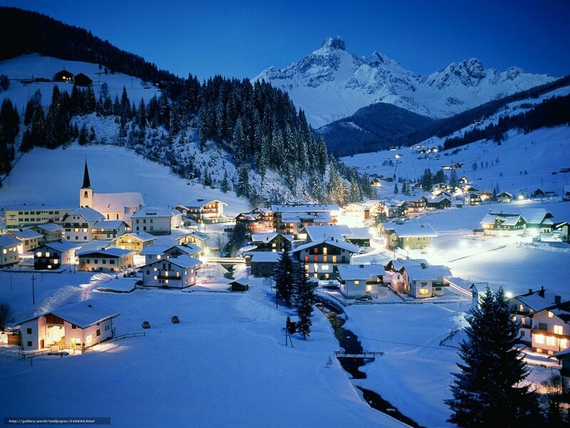Snowy mountain village at night