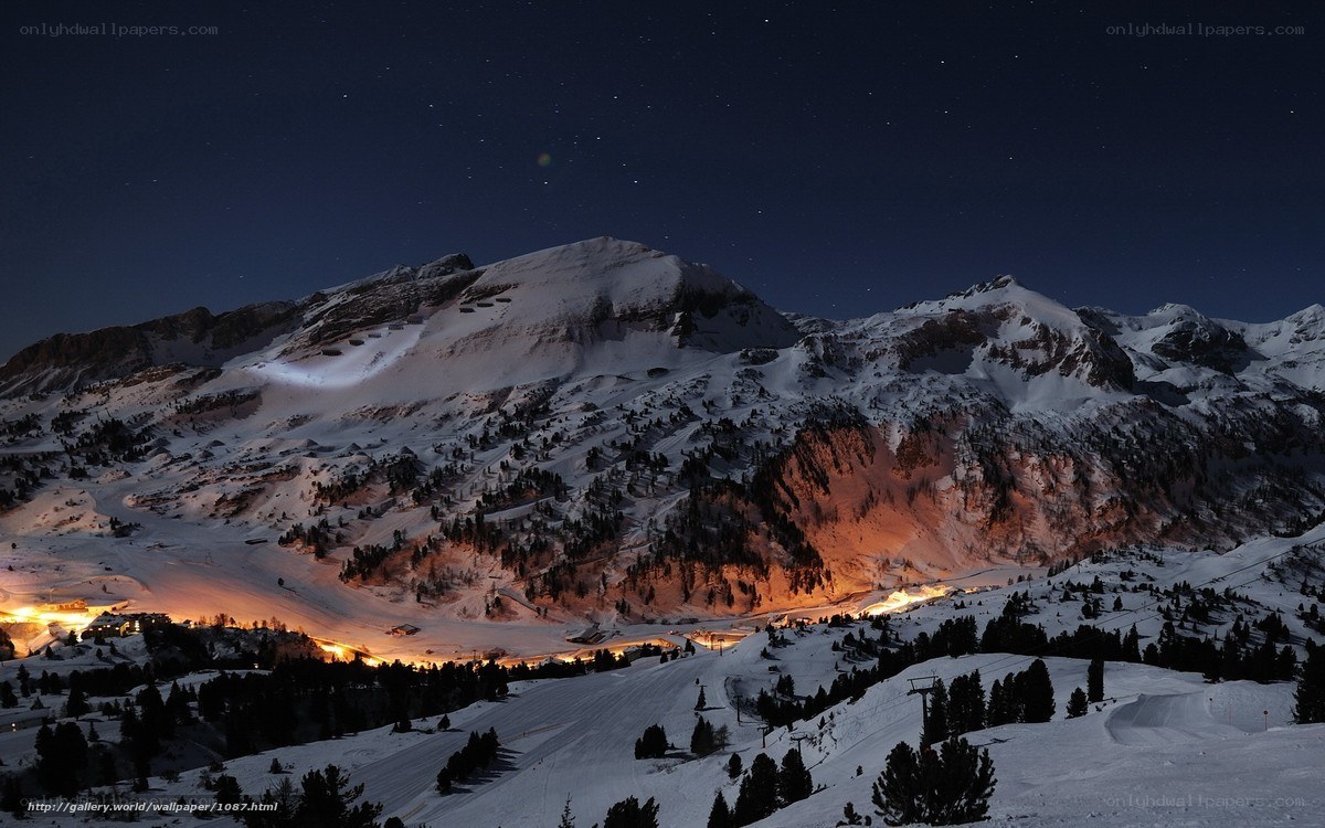 Snowy mountain village at night