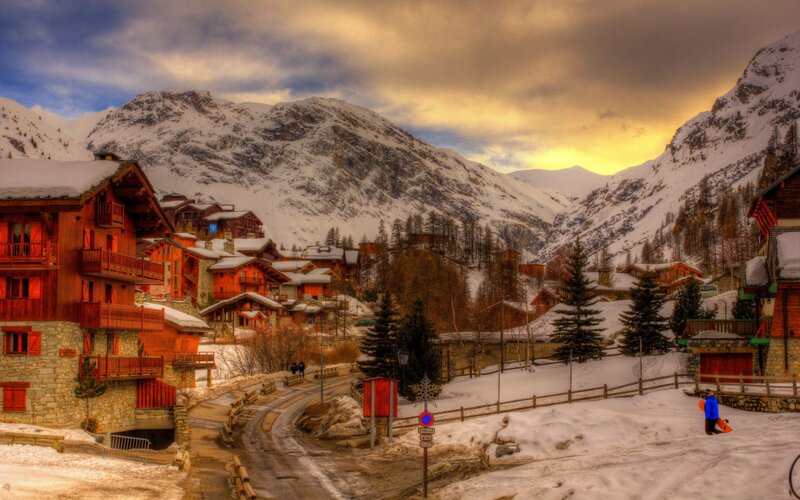Snowy mountain village at sunset