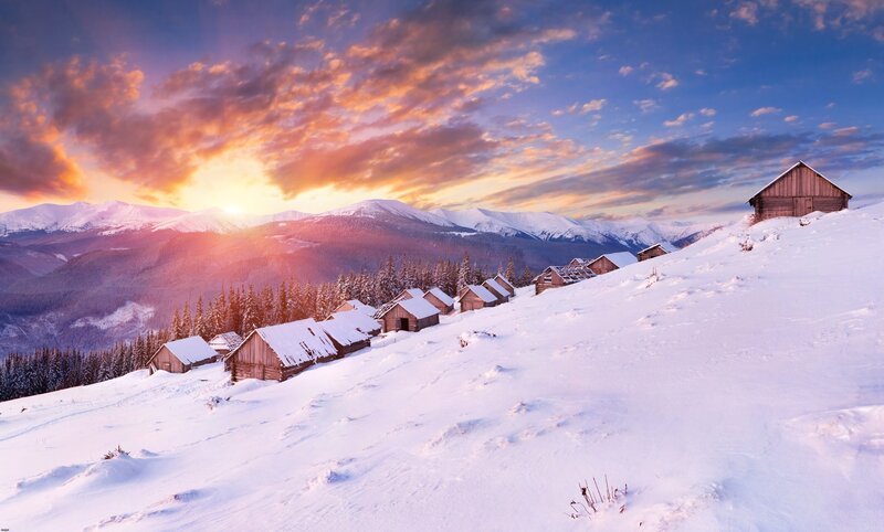 Snowy mountain village at sunset