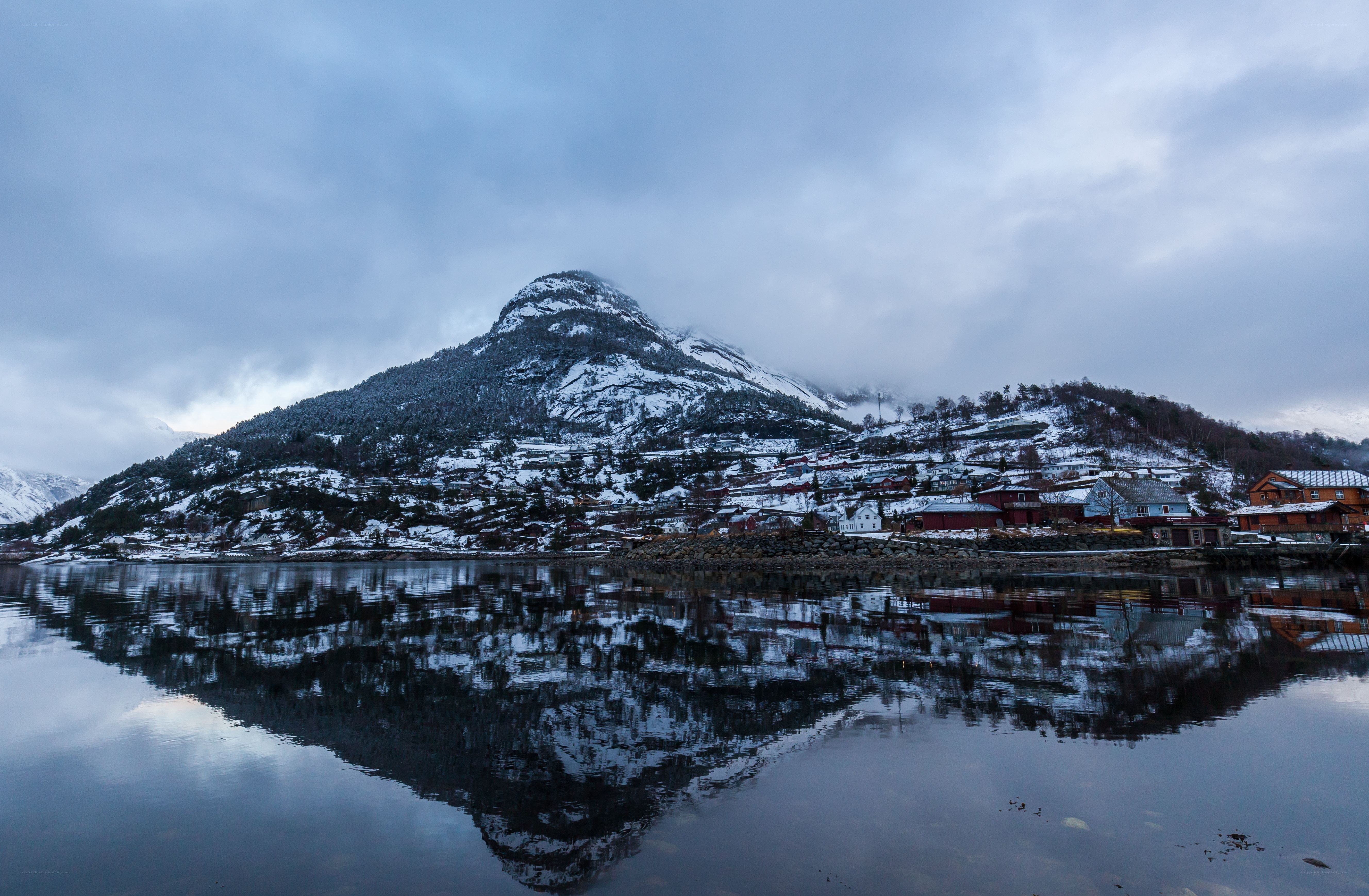 Snowy mountain village reflection