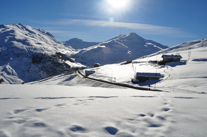 Snowy mountain village under sun