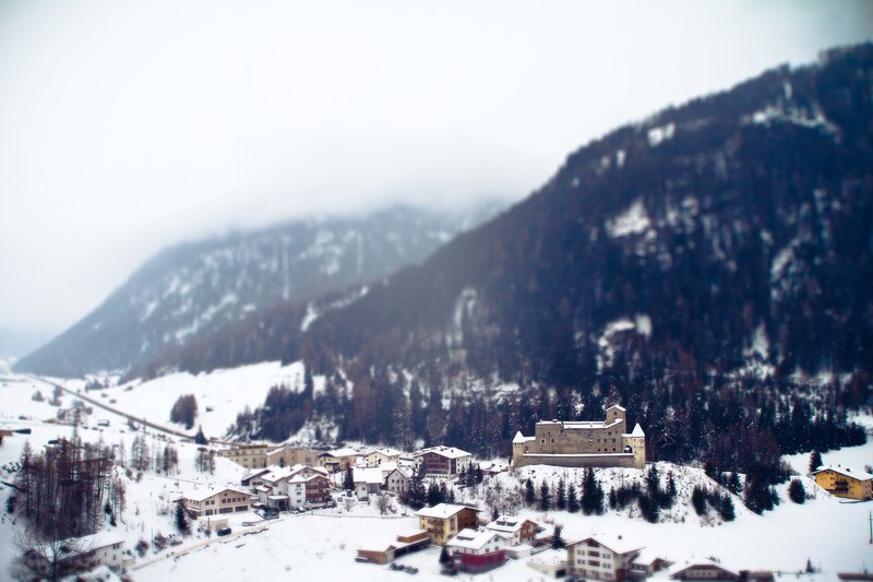 Snowy mountain village with castle