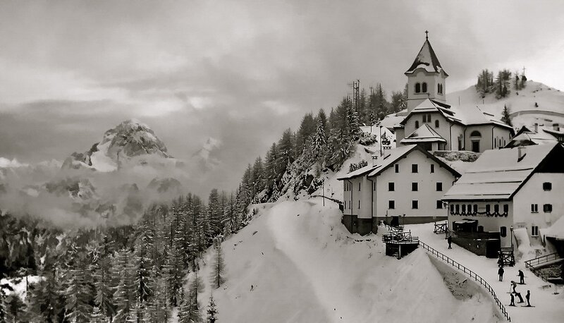 Snowy mountain village with church