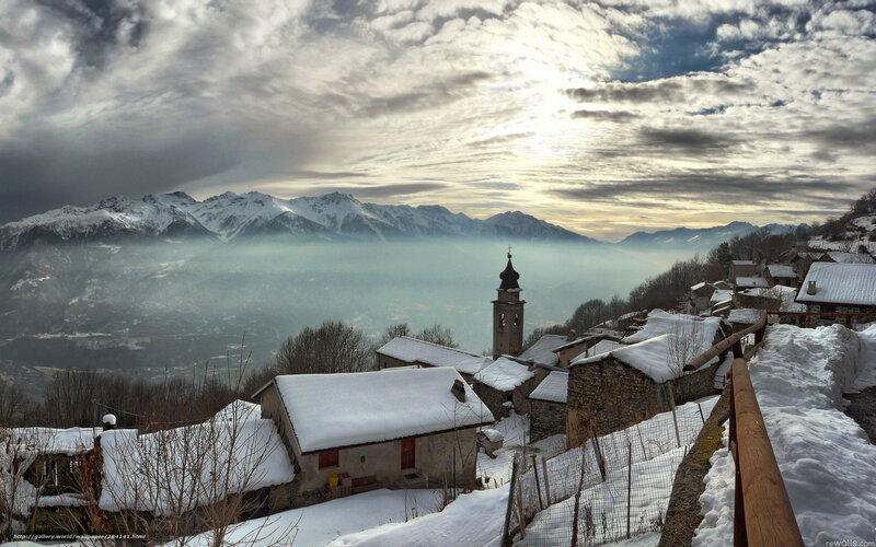 Snowy mountain village with church