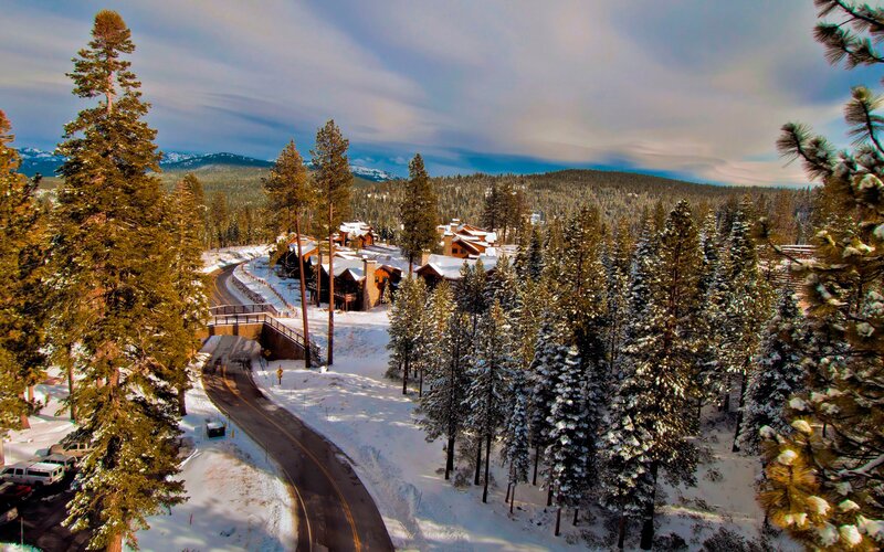 Snowy mountain village with winding road
