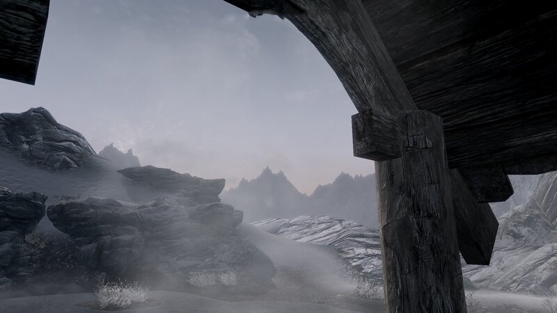 snowy mountain vista from ruin