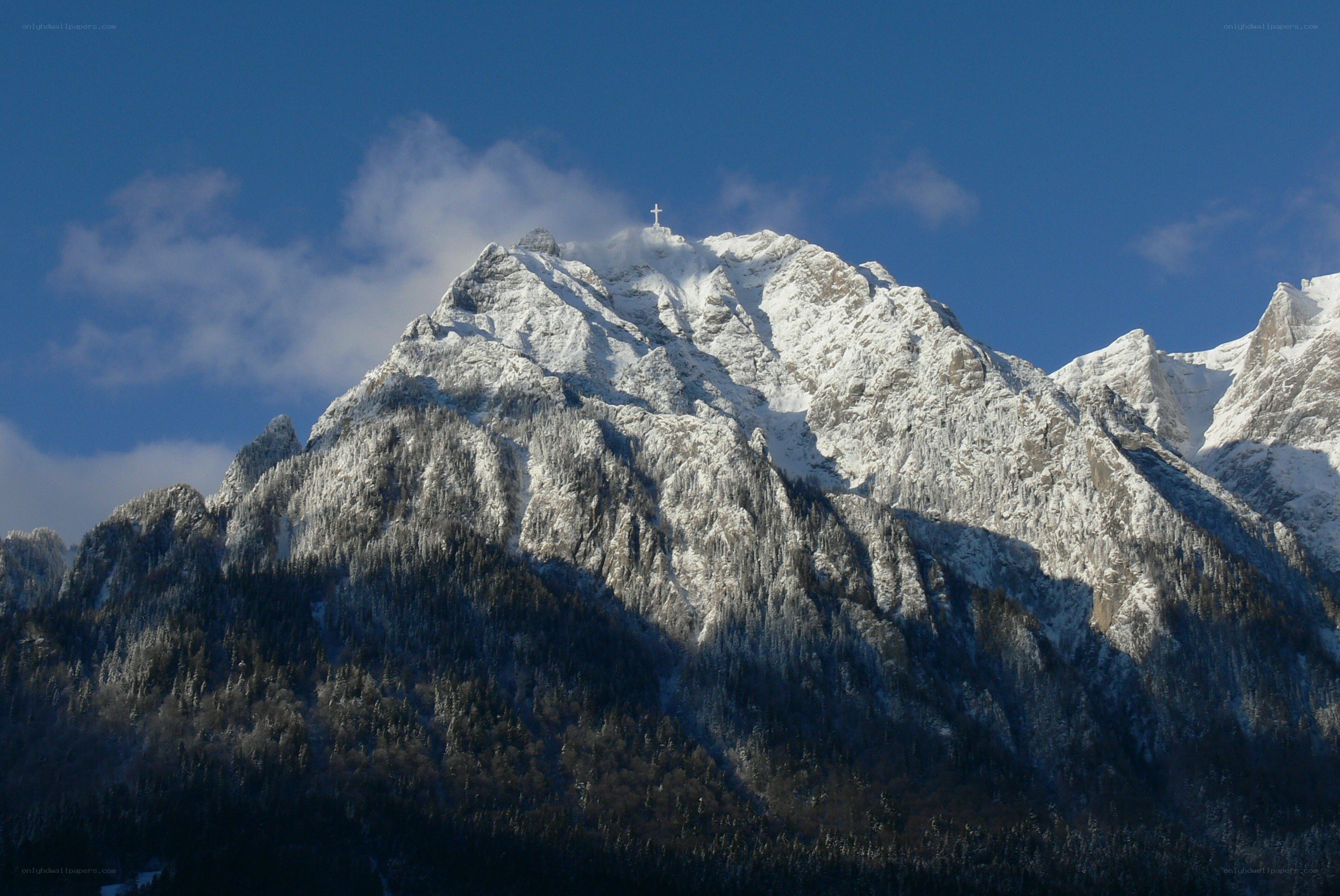 Snowy mountain with cross