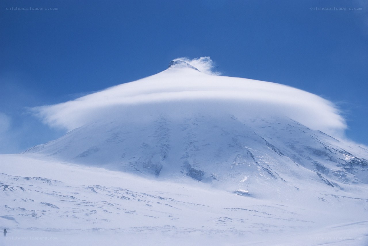 Snowy mountain with lenticular cloud