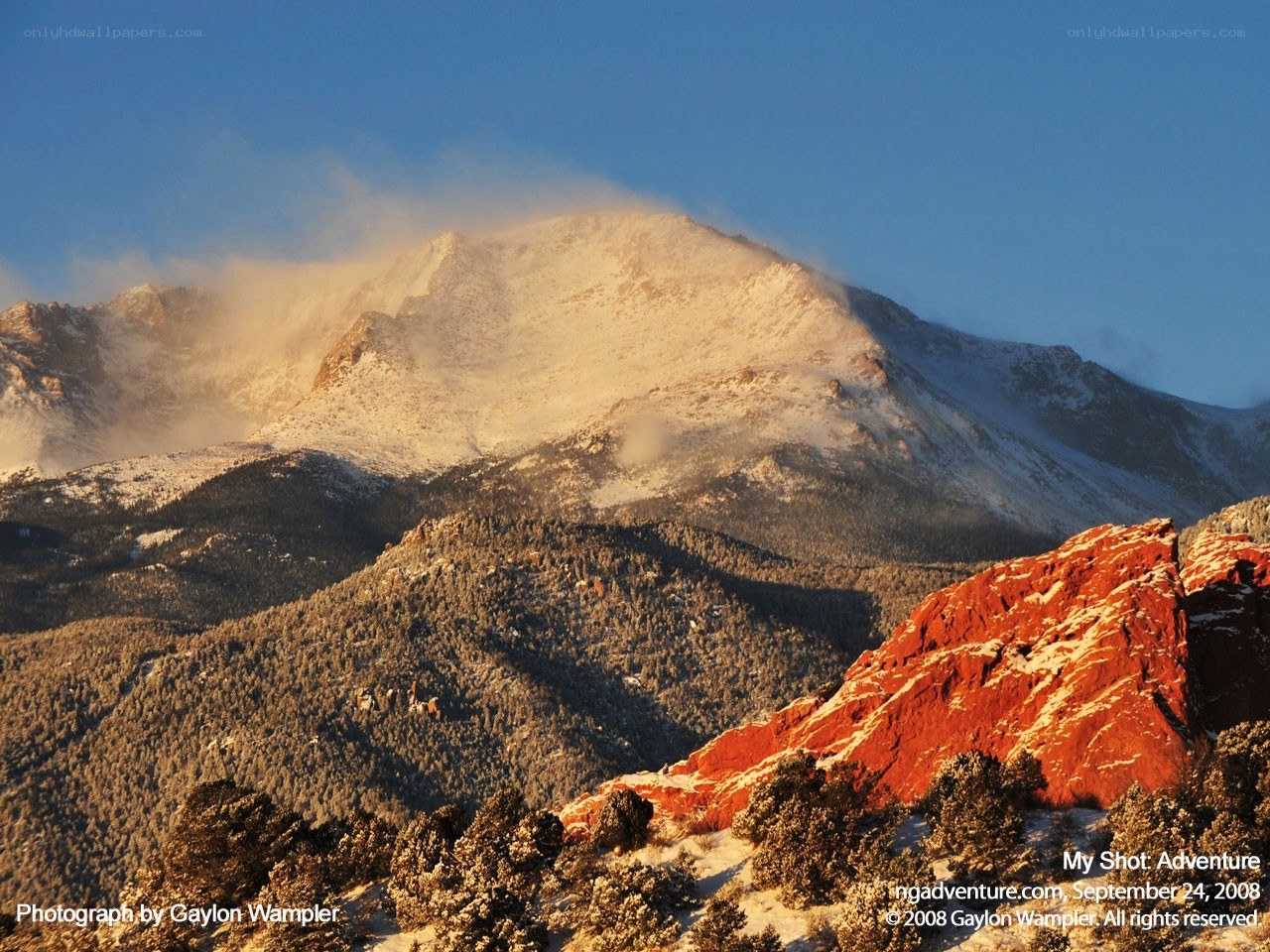 Snowy mountain with red rocks