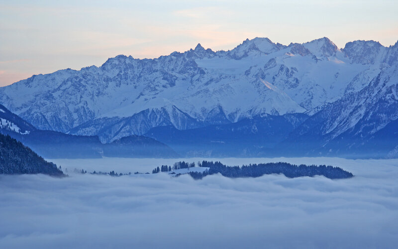 Snowy mountains above a sea of clouds