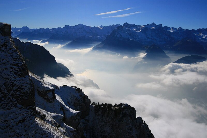 Snowy mountains above clouds