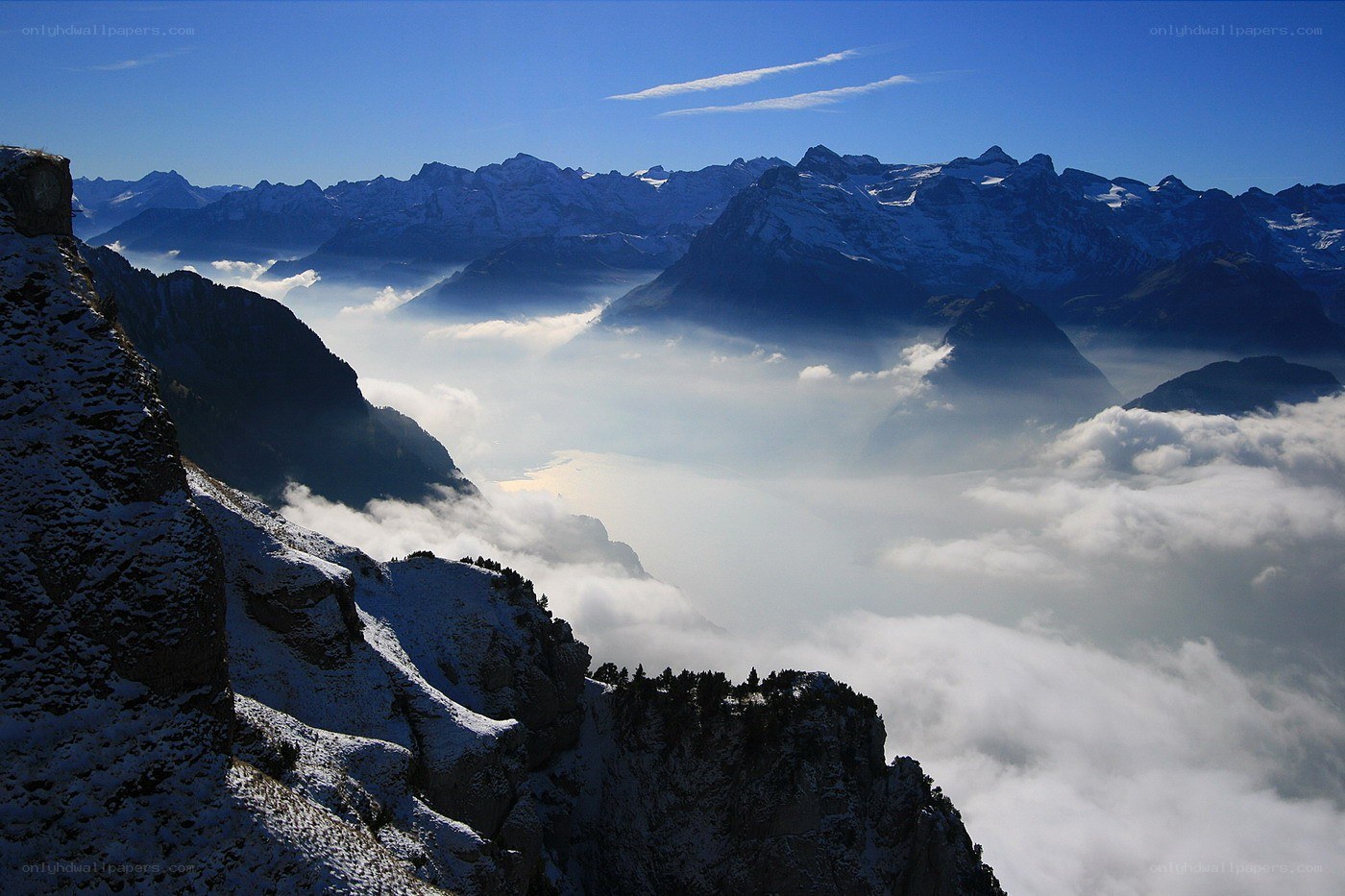 Snowy mountains above clouds