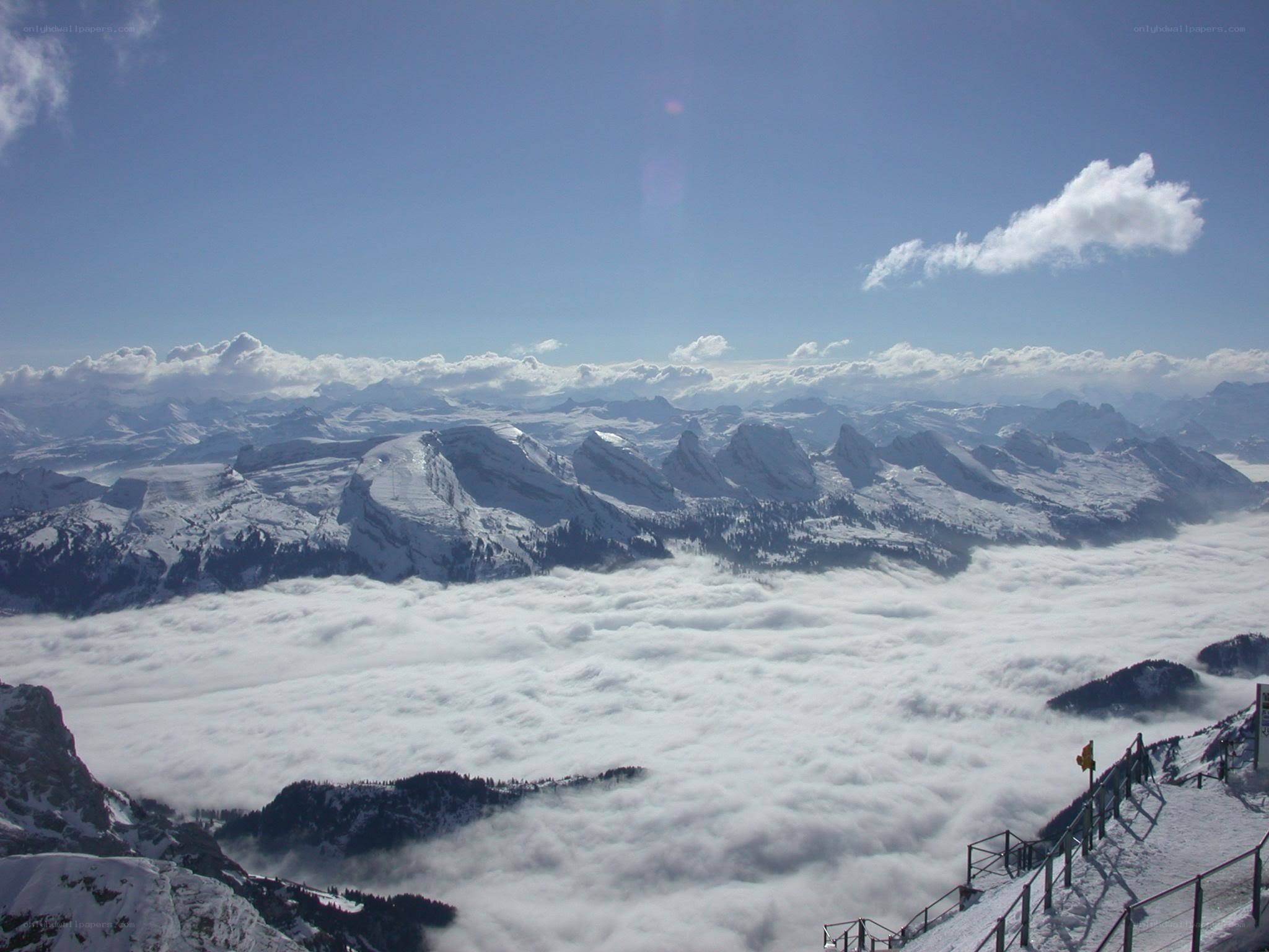 snowy mountains above clouds
