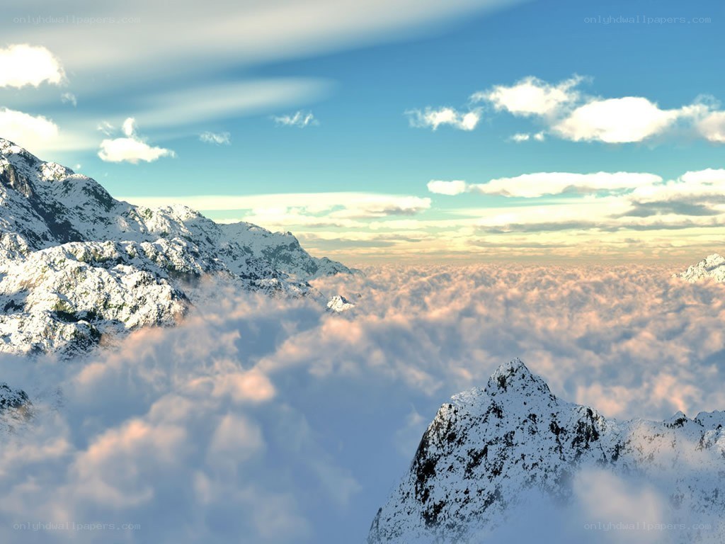 snowy mountains above clouds