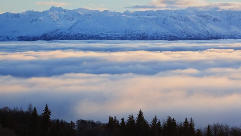 Snowy mountains above clouds