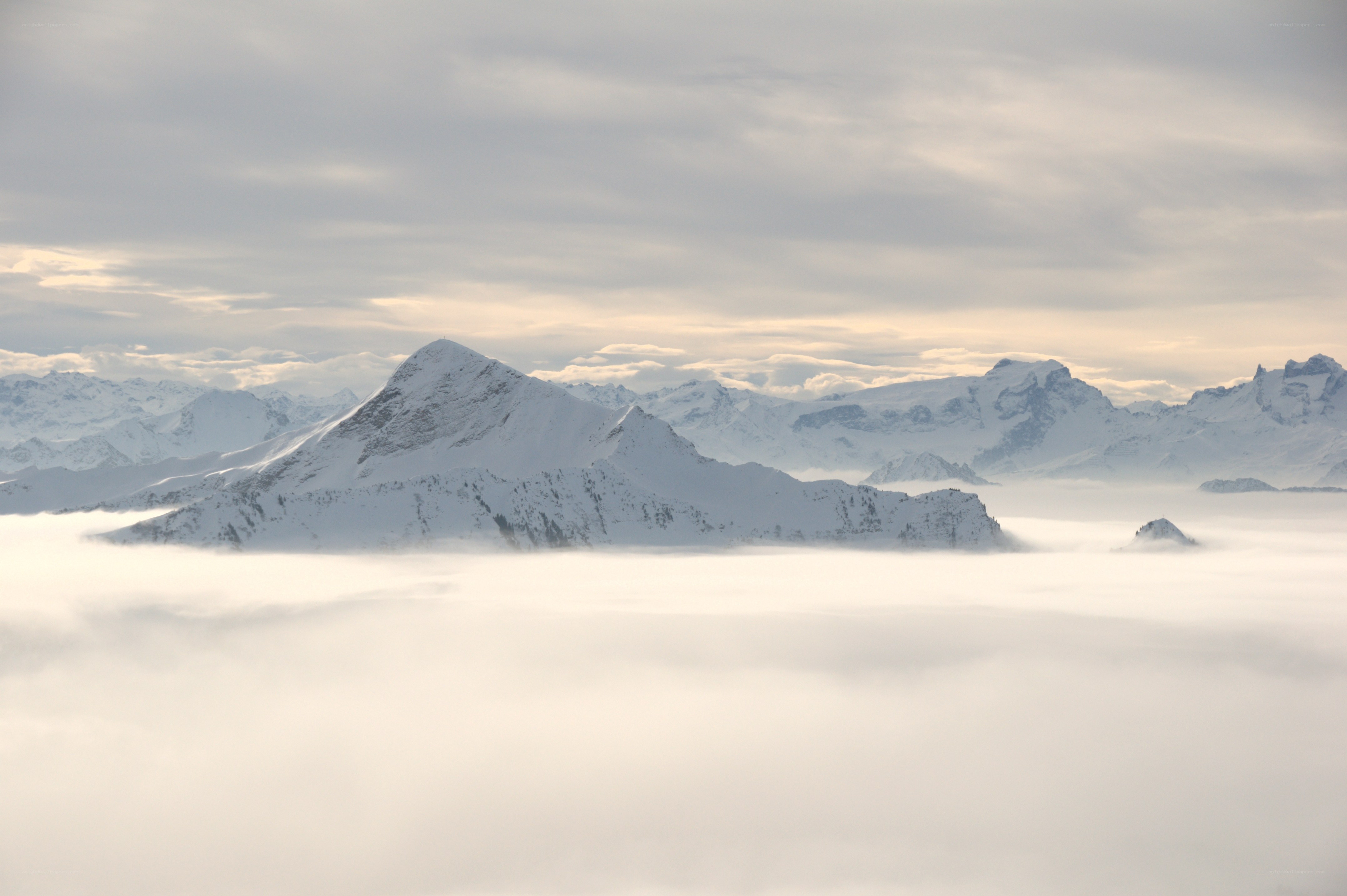 Snowy mountains above clouds