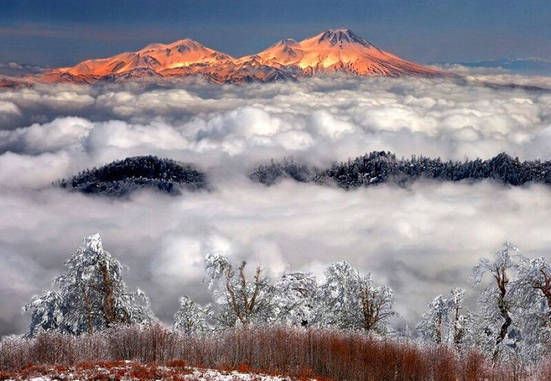 Snowy mountains above clouds