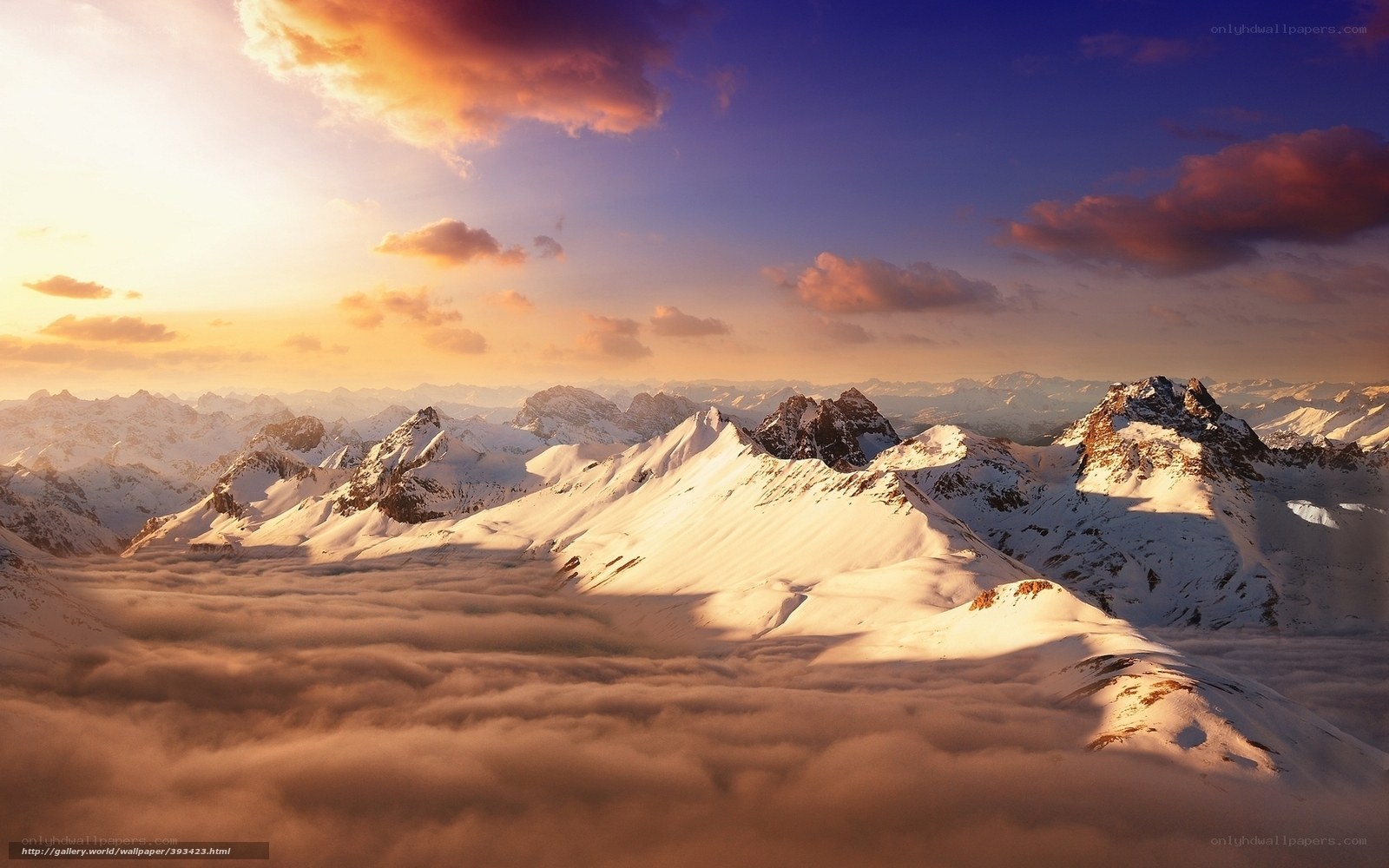 Snowy mountains above clouds