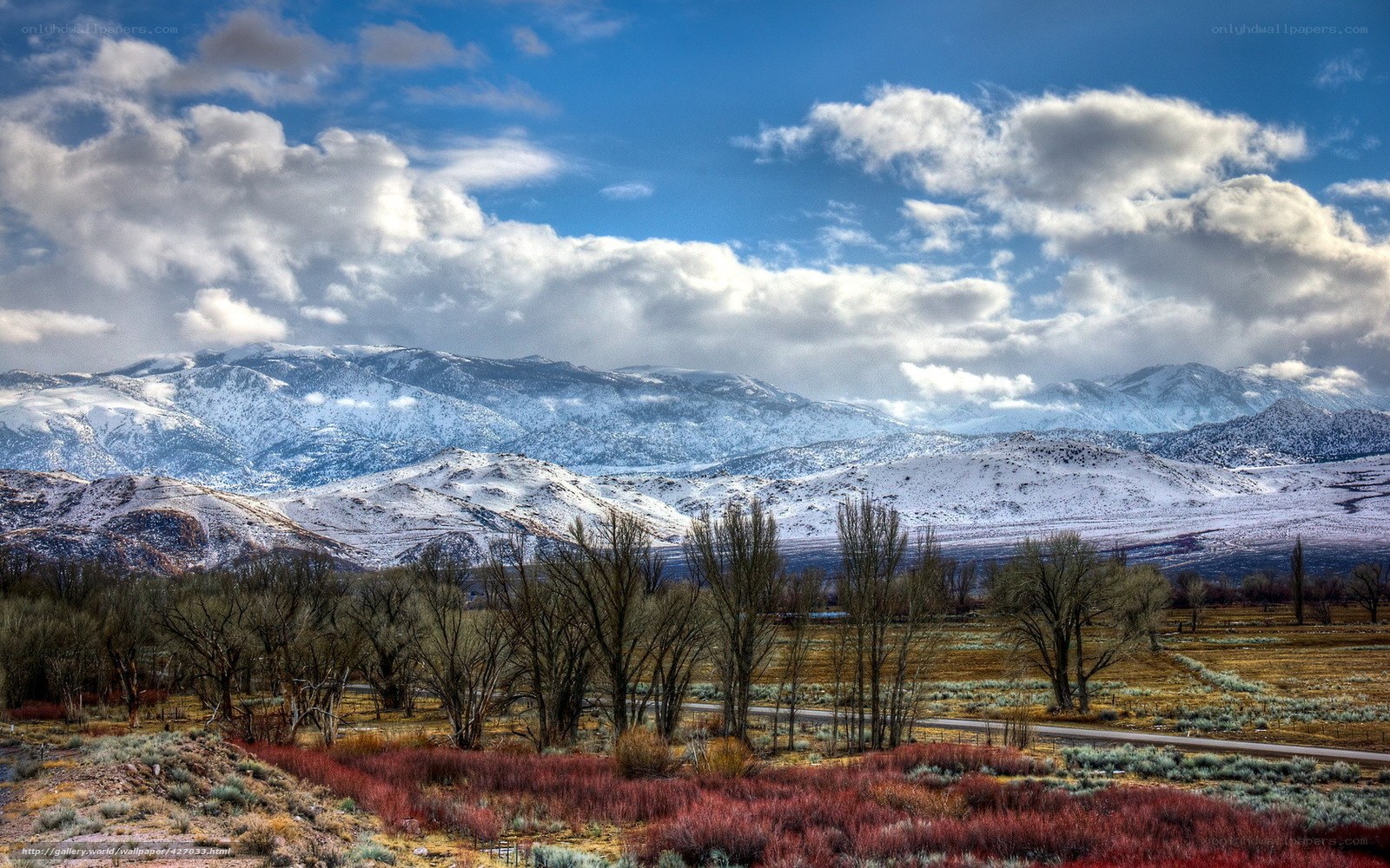 Snowy mountains and autumn valley