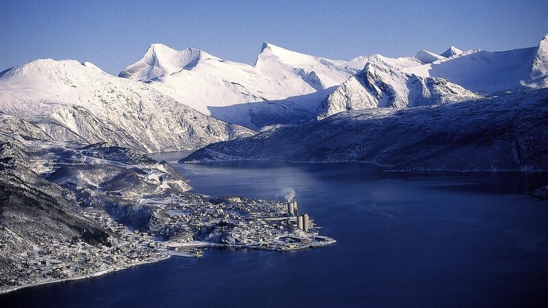 Snowy mountains and fjord town