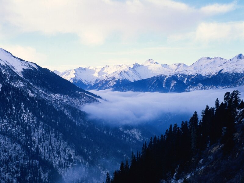 Snowy mountains and foggy valley