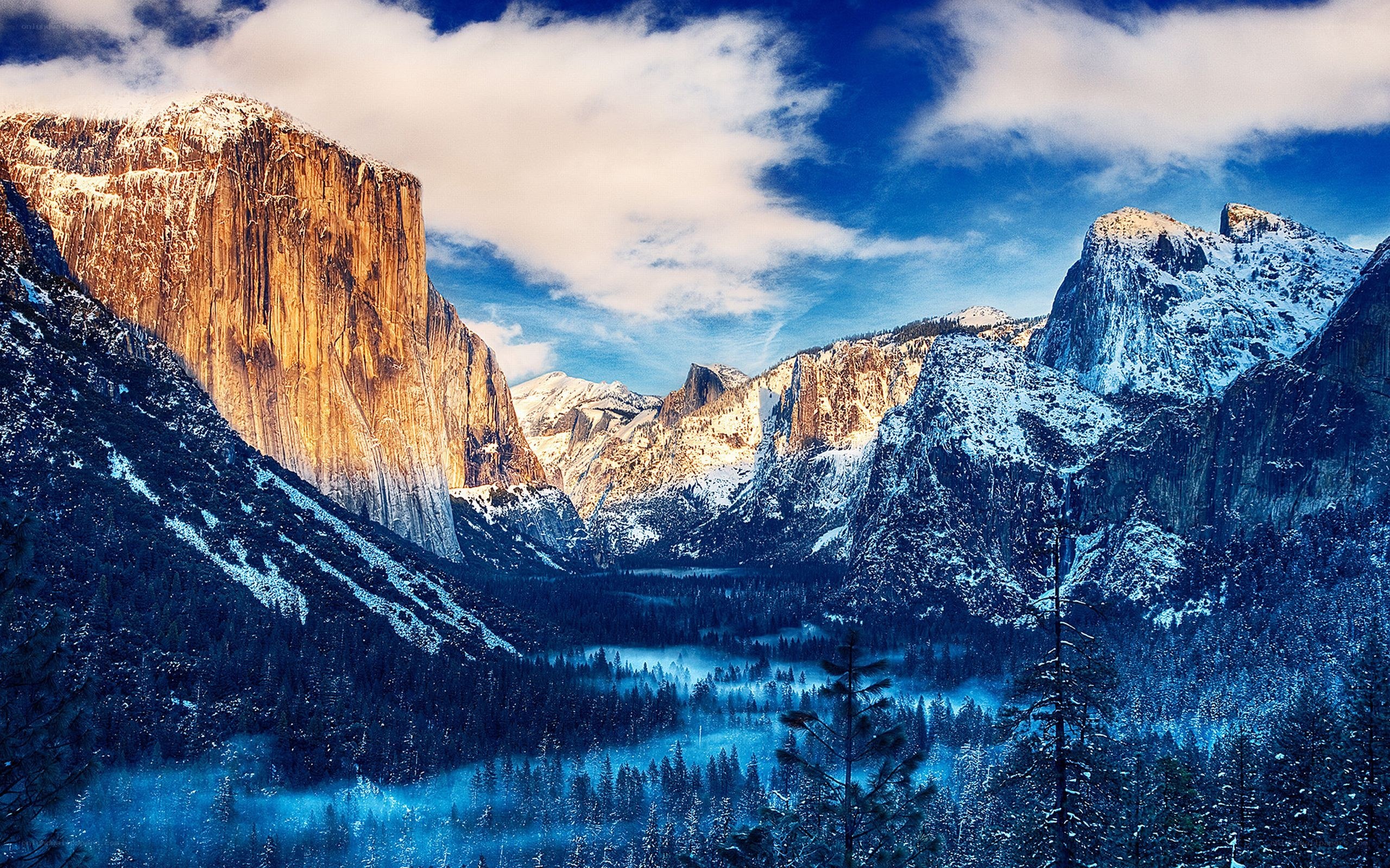 Snowy mountains and forest valley