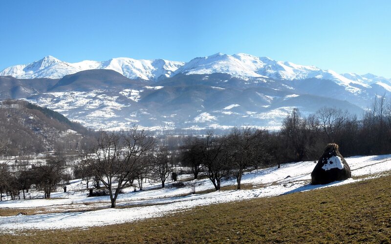 Snowy mountains and hay stack