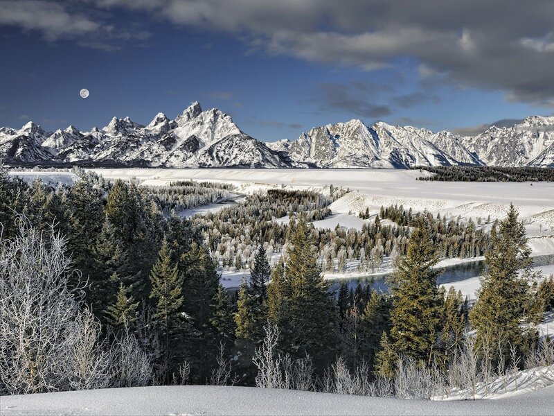 Snowy mountains and moonlit landscape
