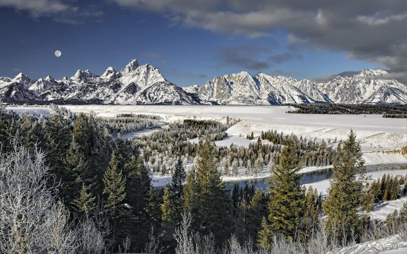 Snowy mountains and moonlit landscape