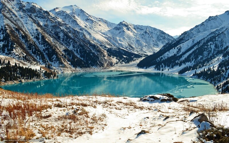 snowy mountains and turquoise lake