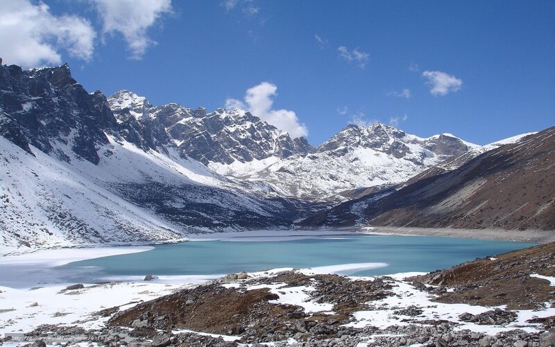 Snowy mountains and turquoise lake