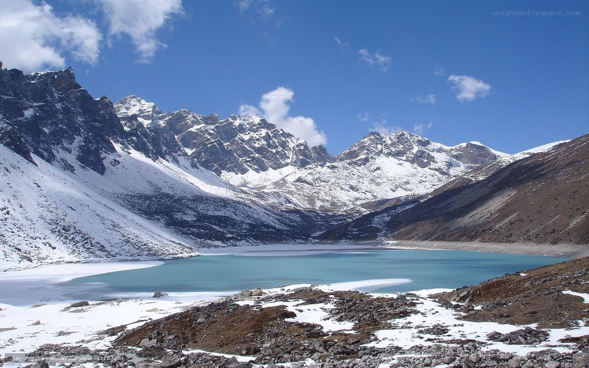 Snowy mountains and turquoise lake