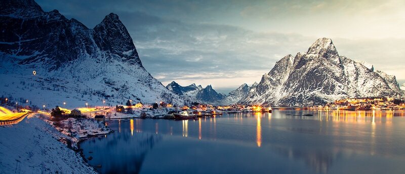 Snowy mountains and village at dusk
