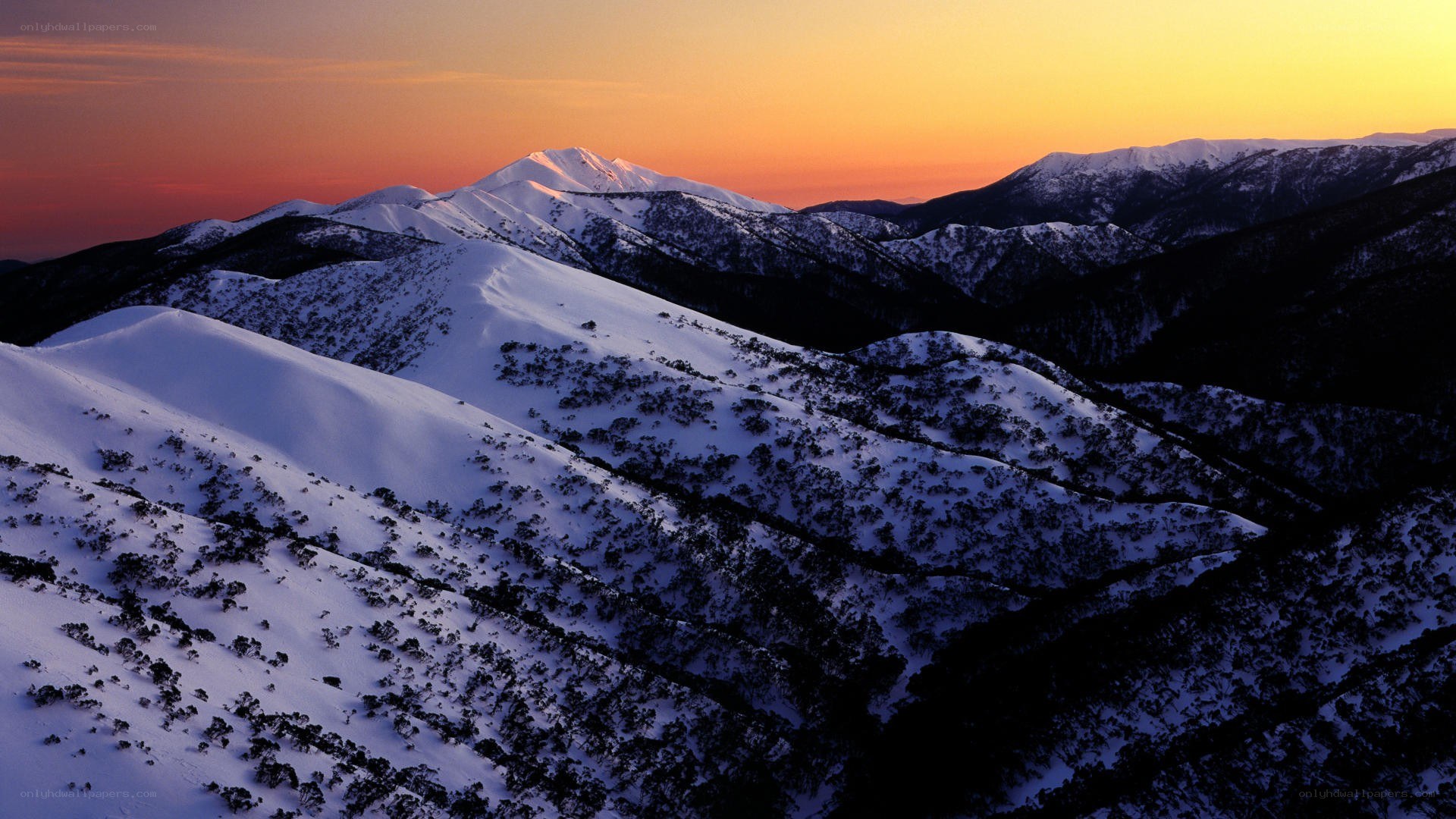Snowy mountains at sunset