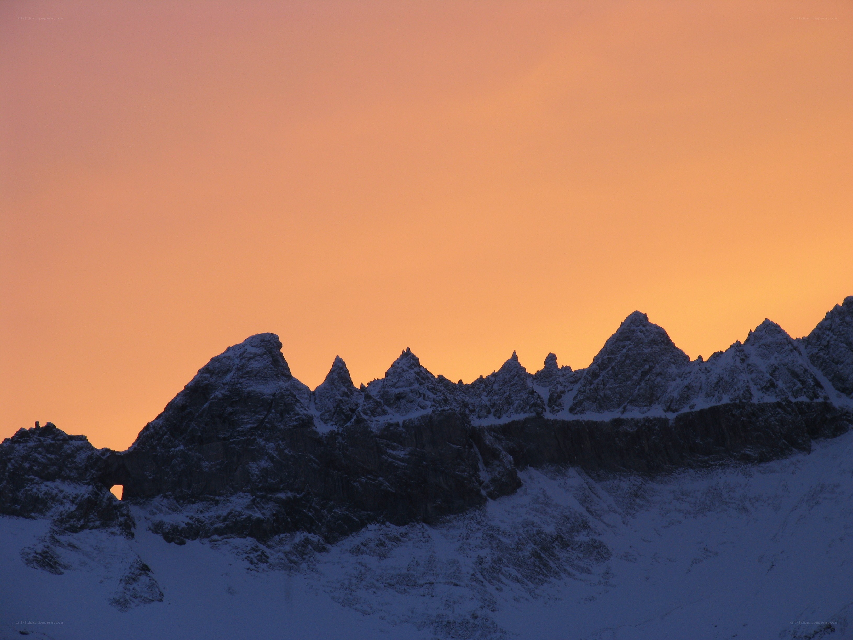 snowy mountains at sunset
