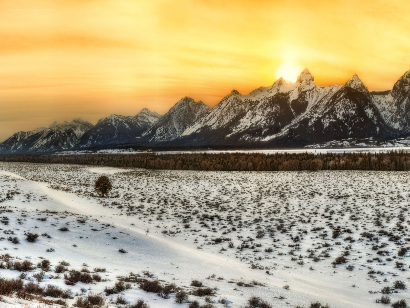 Snowy mountains at sunset