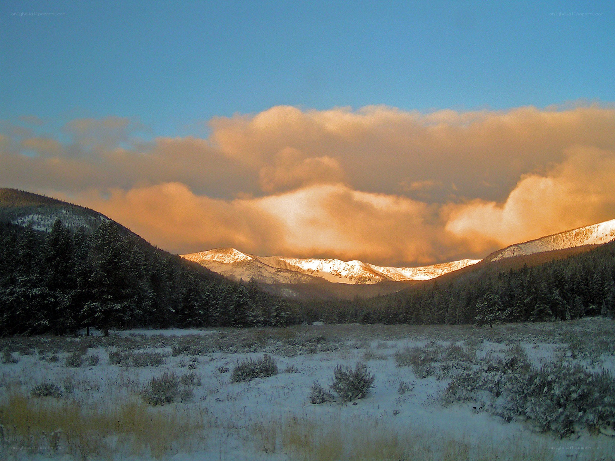 Snowy mountains at sunset