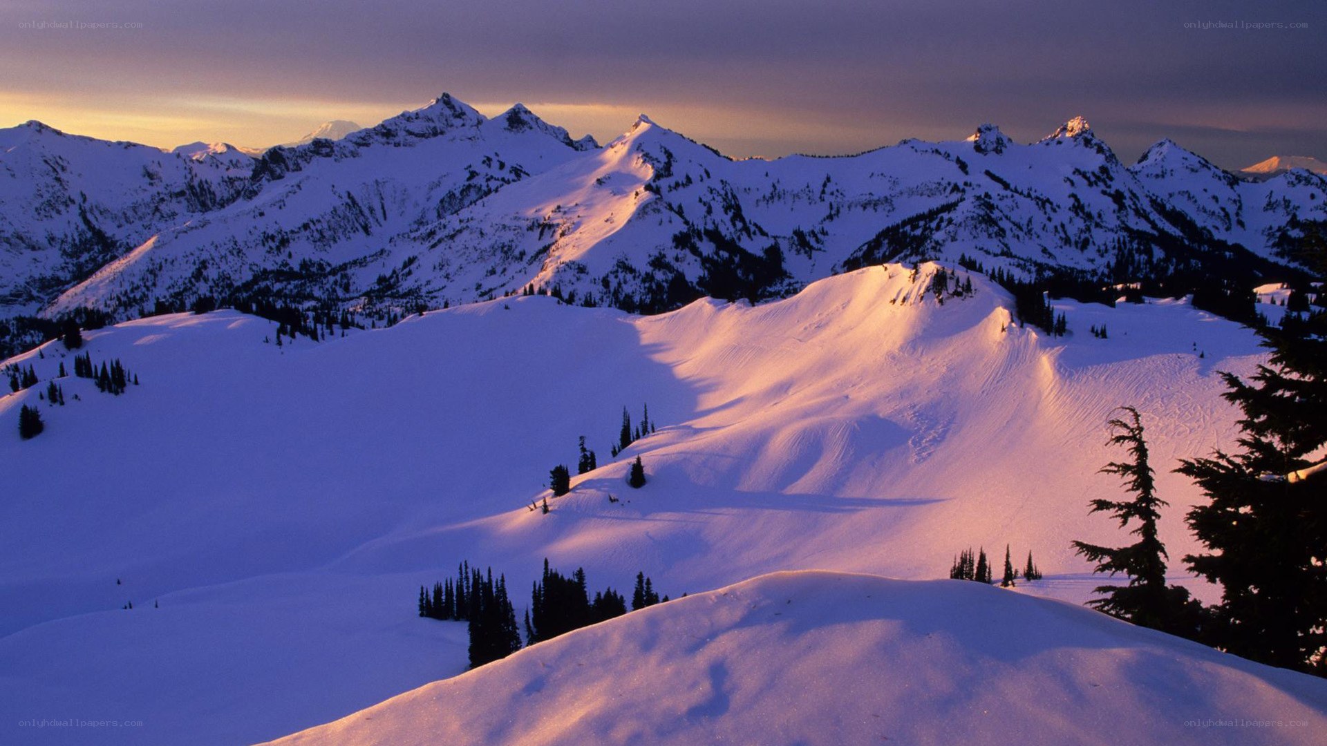 snowy mountains at sunset