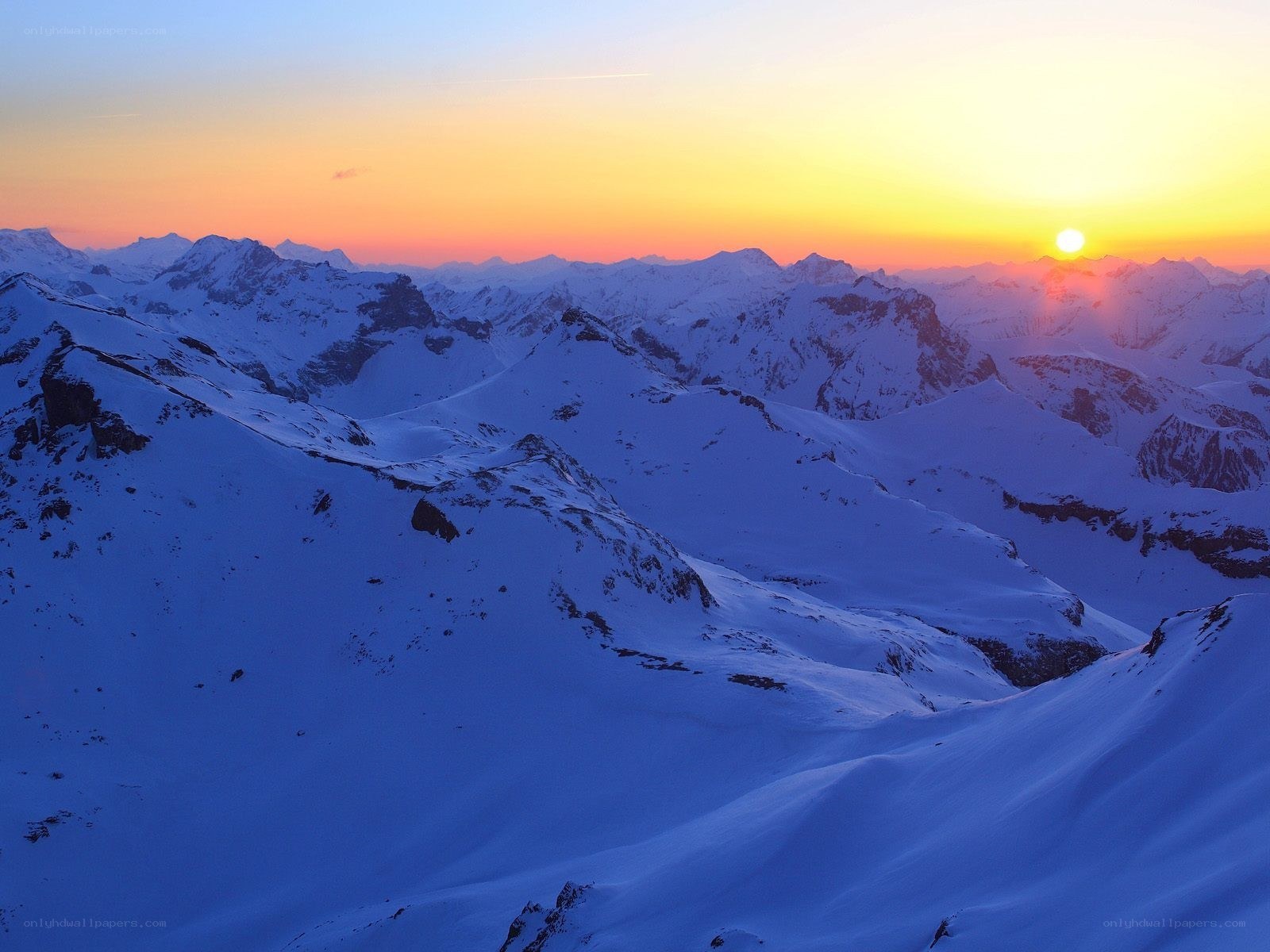 Snowy mountains at sunset