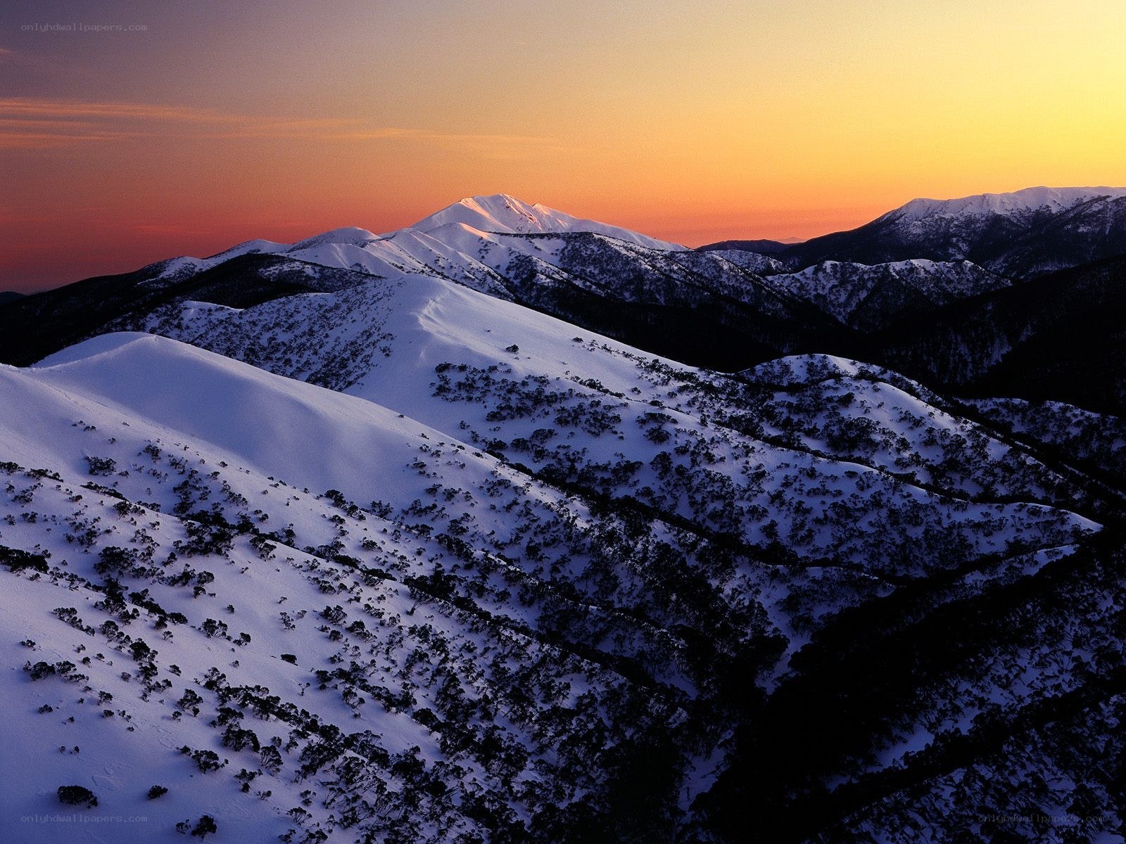 Snowy mountains at sunset