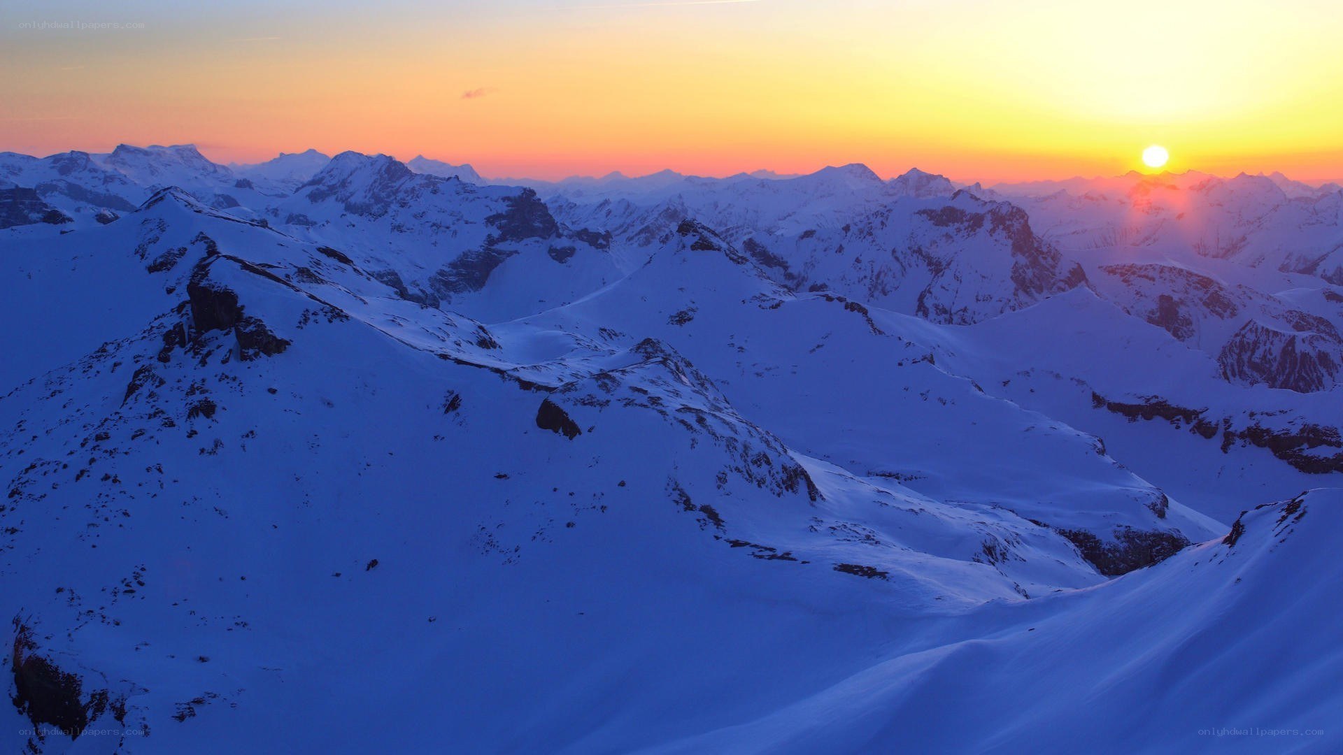 snowy mountains at sunset