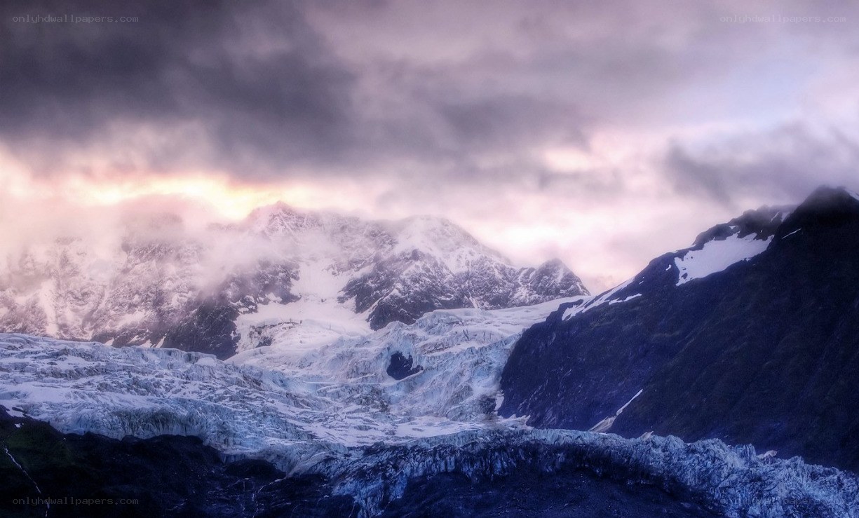 snowy mountains at sunset