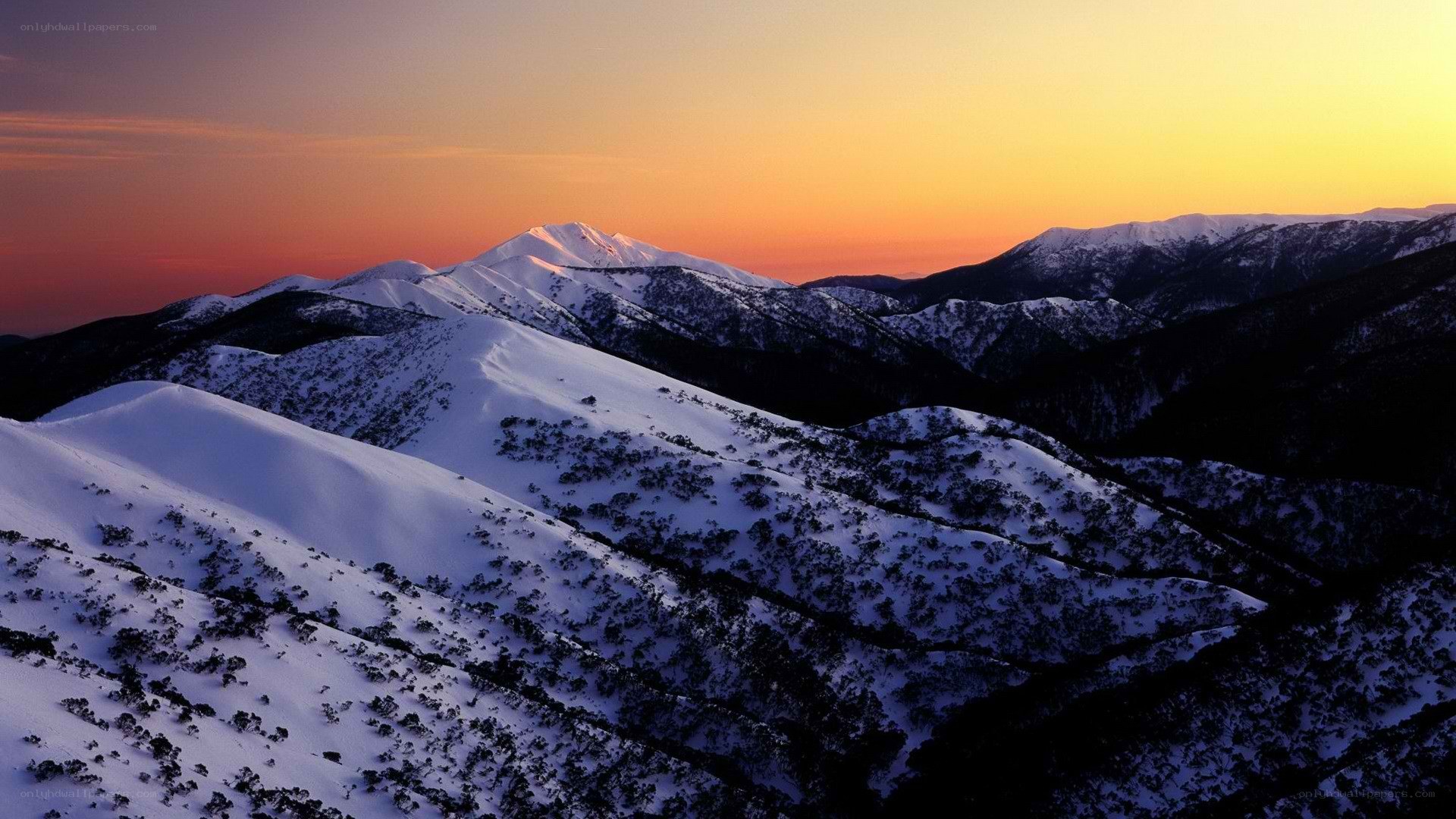 snowy mountains at sunset