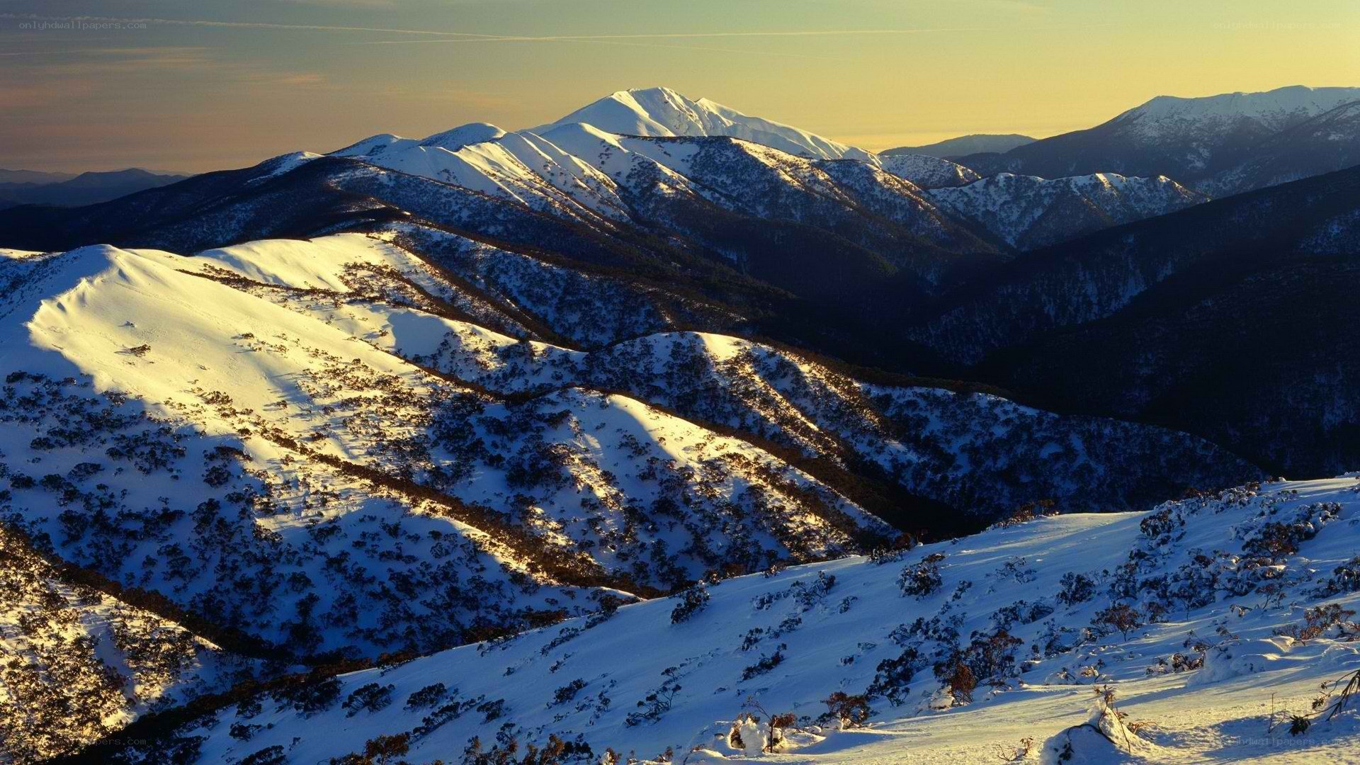 snowy mountains at sunset