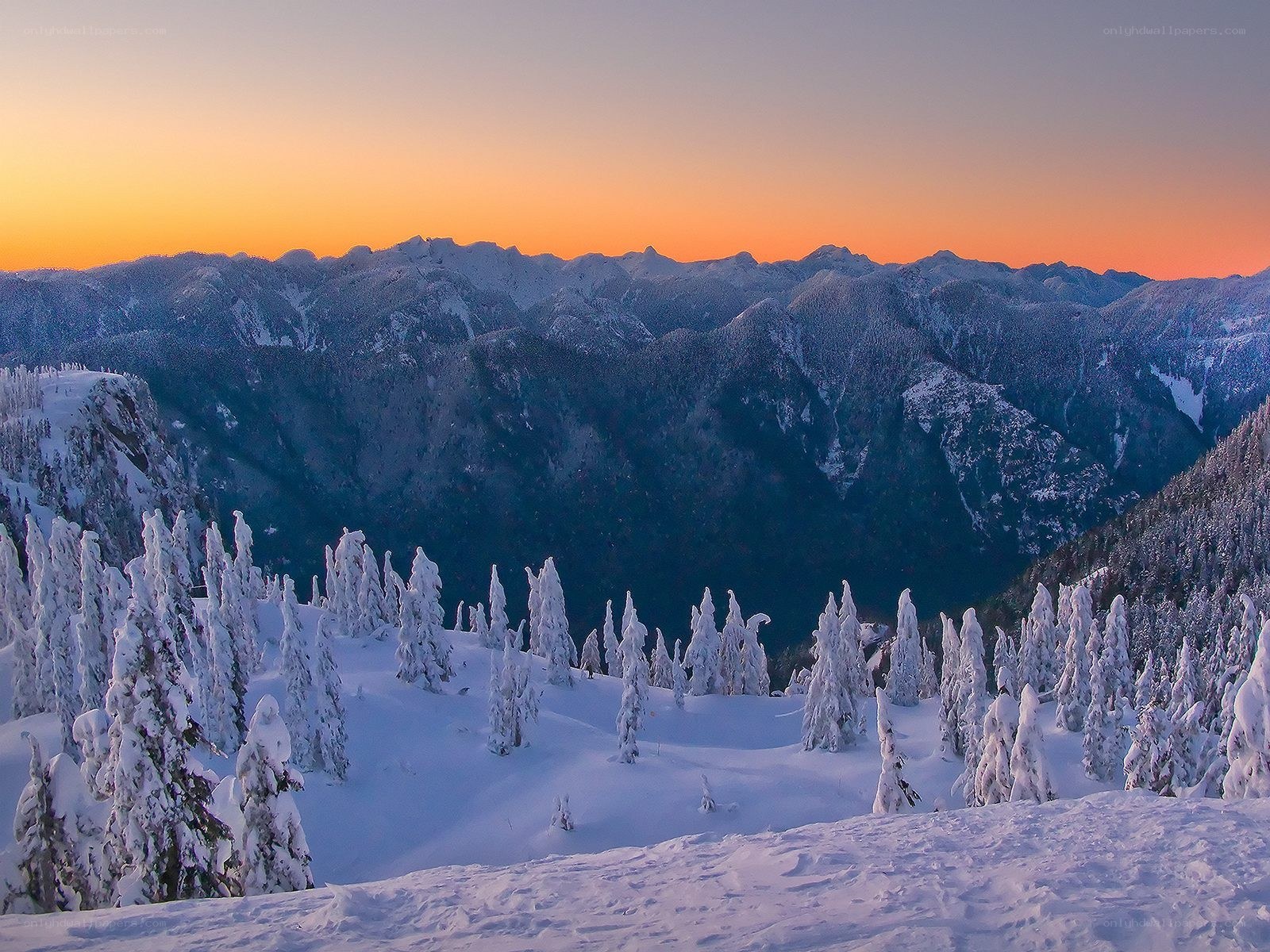 Snowy mountains at sunset