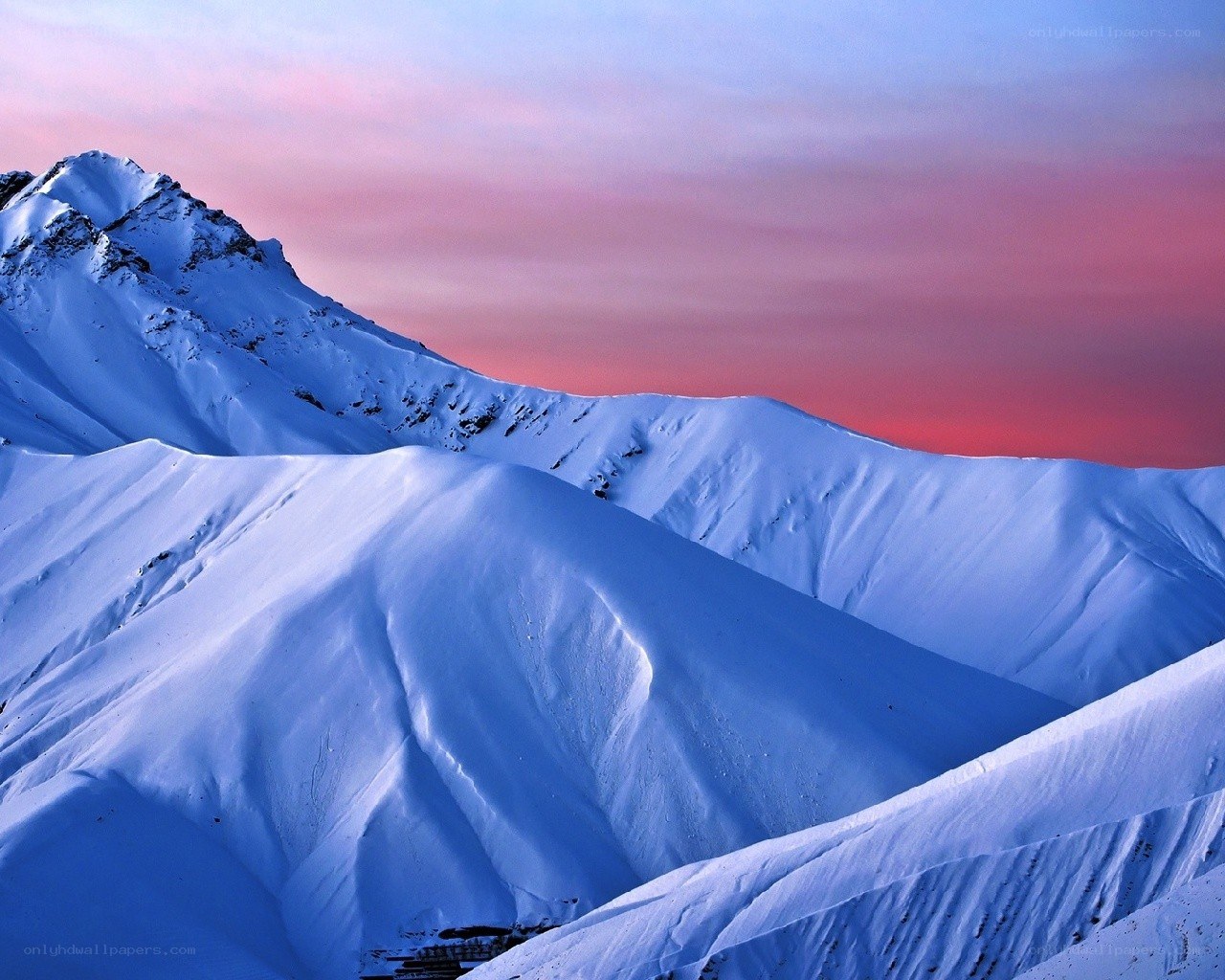 Snowy mountains at sunset