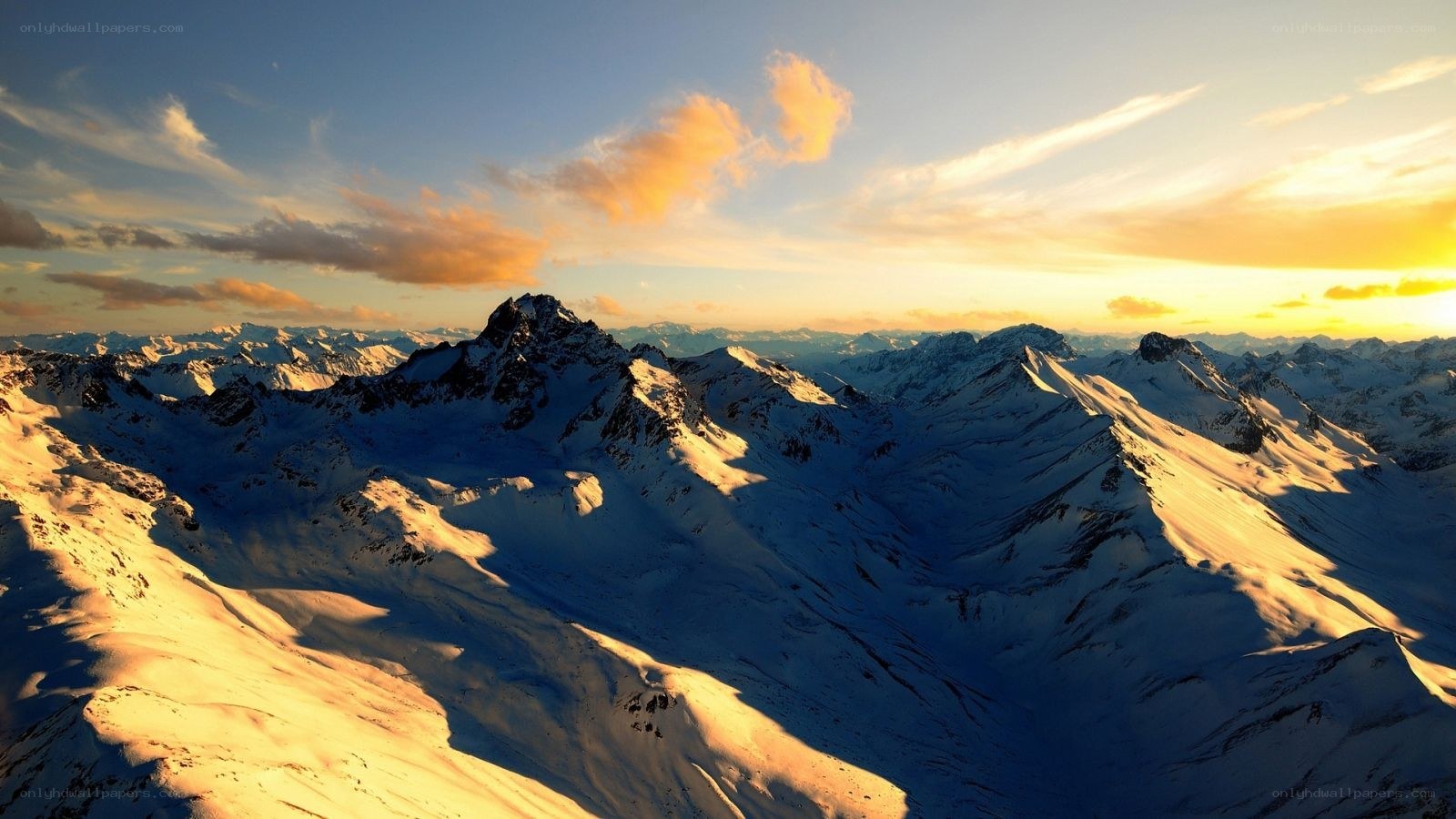 Snowy mountains at sunset