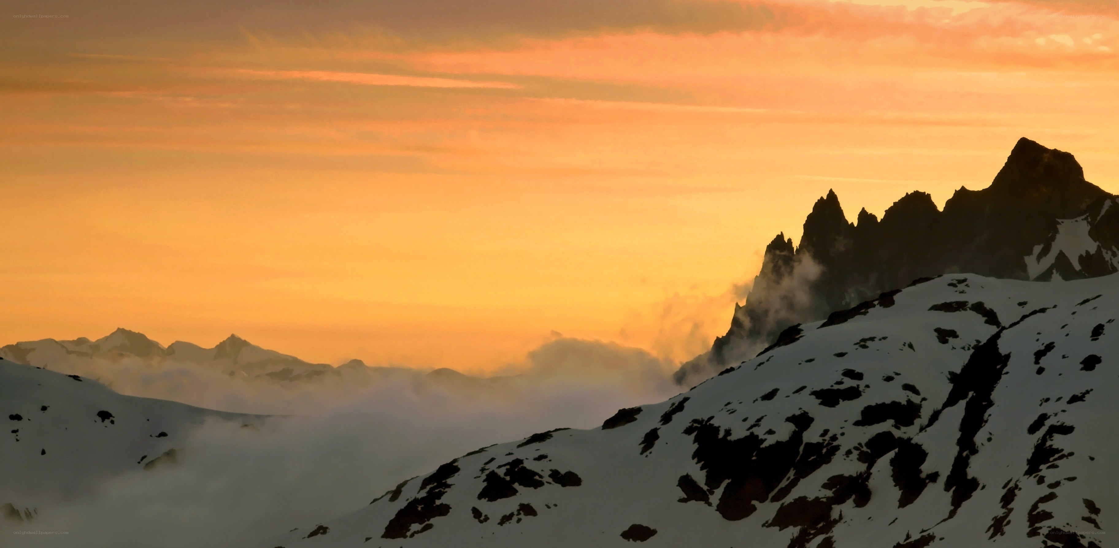 Snowy mountains at sunset